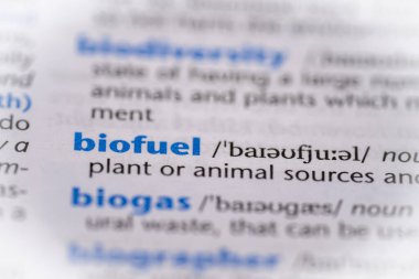 Biofuel word in a dictionary. Selective focus, close up. clipart