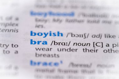 Bra word in a dictionary. Selective focus, close up. clipart