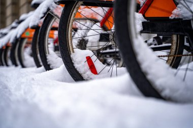Karla kaplı bisiklet tekerleklerinin yakın görüntüsü.