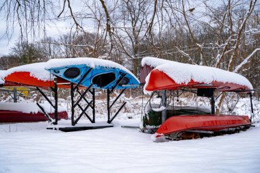 Snow-covered canoes in winter. clipart