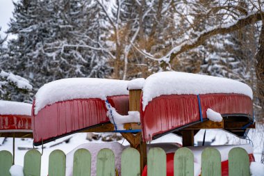 Snow-covered canoes in winter. clipart