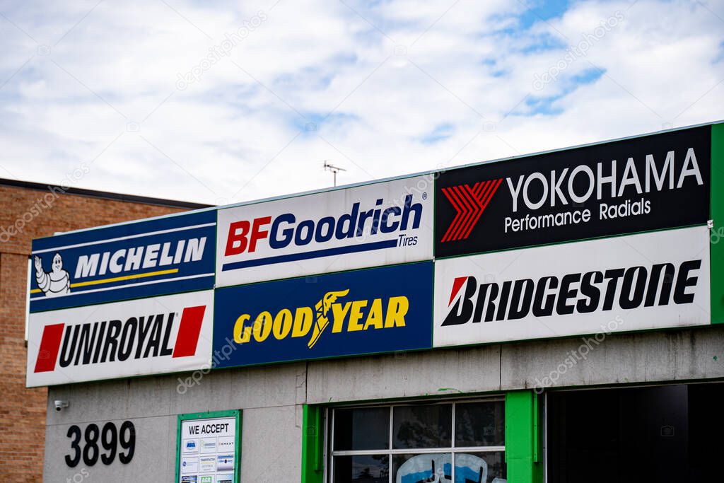 View Of Auto Repair Shop Sign Showing Brand Logos. Markham, Canada - May 17, 2025.