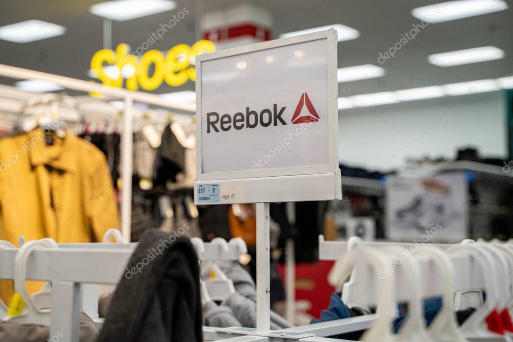 Reebok clothing section sign inside retail store. Toronto, Canada - October 3, 2025.