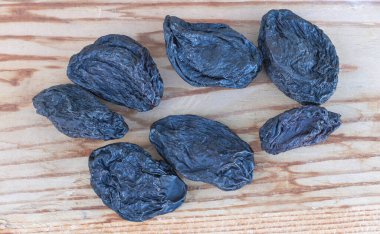 Natures Sweetness: A Shot of Dried Plums on a Wooden Background.