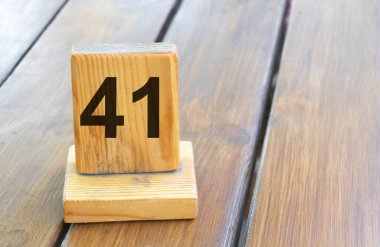 Wooden priority number 41 on a plank tab.
