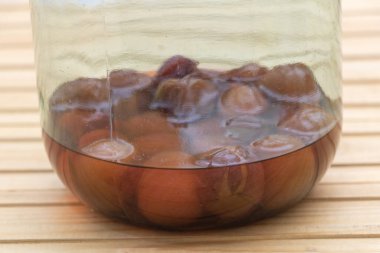 Enjoying Every Last Bit: Plum Compote in a Nearly Empty Jar.