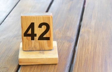 Wooden priority number 42 on a plank tab.