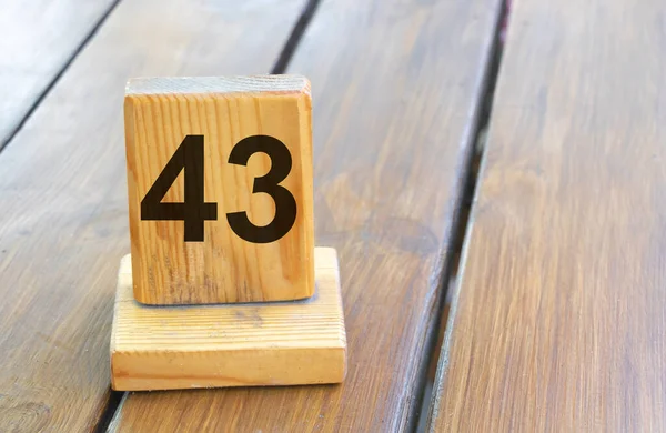 stock image Wooden priority number 43 on a plank tab.