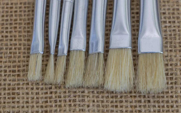 Paint Brushes Burlap Background Closeup Photo — Stock Photo, Image