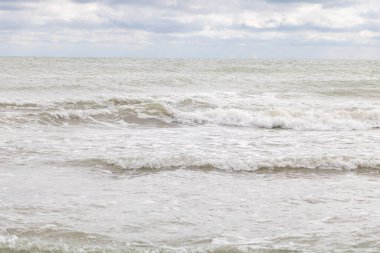 Deniz kıyısında bulutlu havada dalgalar. Rimini, İtalya.