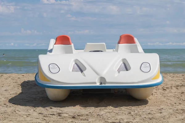 Inflatable rubber fishing boat on sandy beach near sea Stock Photo