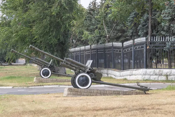 stock image two anti-aircraft guns with white wheels in front of the National Museum.