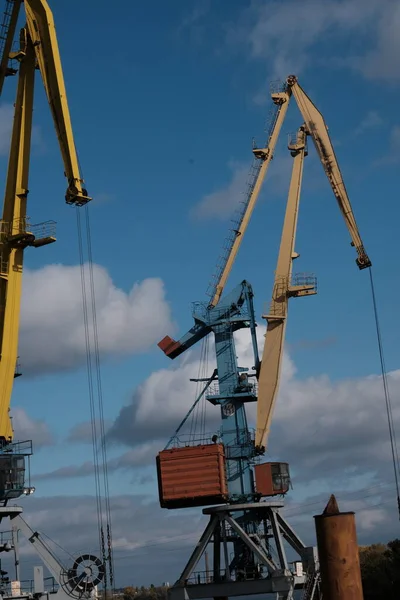 stock image Construction crane during the construction of a high-rise building. Moving a heavy load.Tower cranes are building a house. Concrete building under construction. Construction site