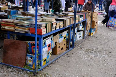 September 24, 2022 Ukraine, Dnipro. Market. Books at the flea market are sold under the open sky. Sale of old editions. Careless handling of books.