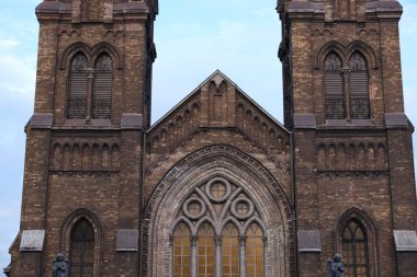 Old catholic church against the sky. Attraction on the territory of Ukraine.Cathedral with towers and stained glass windows