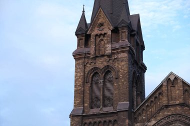 Old catholic church against the sky. Attraction on the territory of Ukraine.Cathedral with towers and stained glass windows