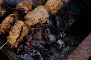 Cooking meat on a charcoal grill. Fried fatty food on a fire. Delicious calorie non vegetarian food. street food kebab