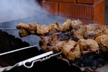 Cooking meat on a charcoal grill. Fried fatty food on a fire. Delicious calorie non vegetarian food. street food kebab