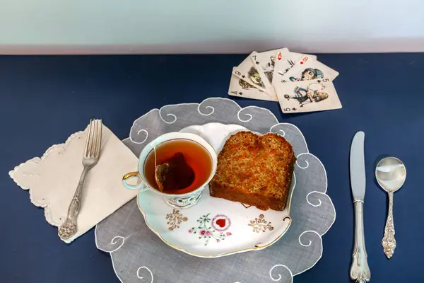 stock image Afternoon tea and carrot cake on a snack dish during a card game.