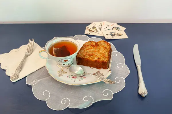 Stock image Afternoon tea and carrot cake on a snack dish during a card game.