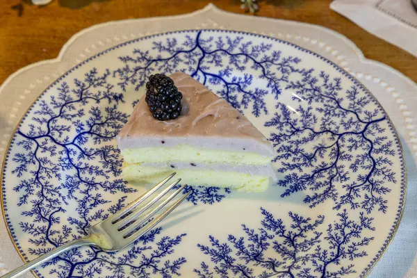 Böğürtlenli ve böğürtlenli Chantilly Pastası. Süslü bir gurme masasında yaban mersinli krema..