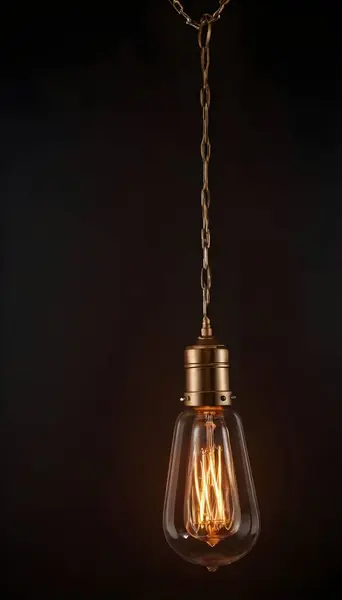 Tek bir Edison ampulü siyah bir kabloya asılı. Ampul parlak bir şekilde parlıyor, çevreye sıcak bir ışık saçıyor..