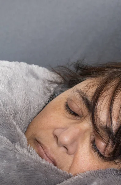 close up of mature woman of Middle Eastern ethnicity sleeping. nap concept