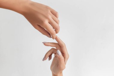 Female Hands Applying Cream, Lotion. Spa and Manicure concept. Female hands with french manicure. Hand Skin Care.