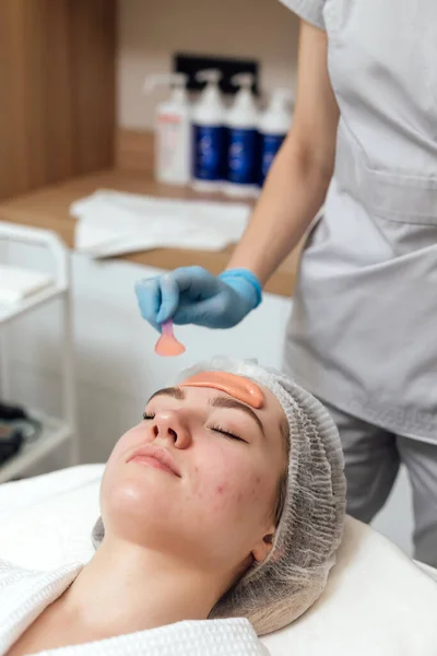 Woman getting face and body treatment at beauty clinic
