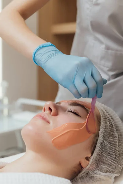 Woman getting face and body treatment at beauty clinic