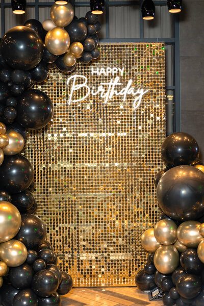 Photo zone with gold glitter, inflatable balls and inscription