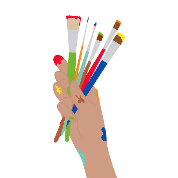 Boya fırçalarını tutan insan eli.