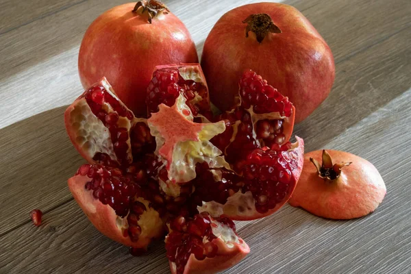 Two Fresh Ripe Pomegranates One Cut Gray Wooden Table Close — Stock Photo, Image