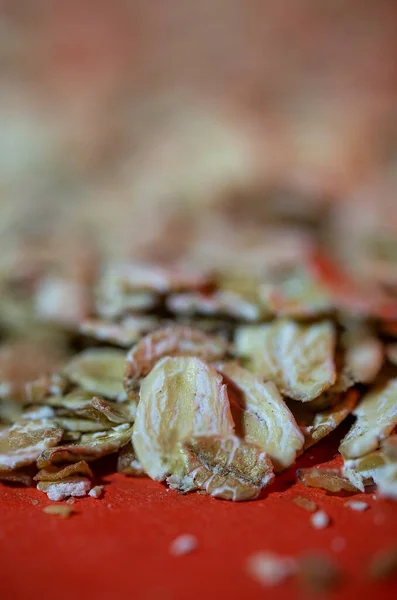 stock image oat flakes on a red background. healthy cereals.