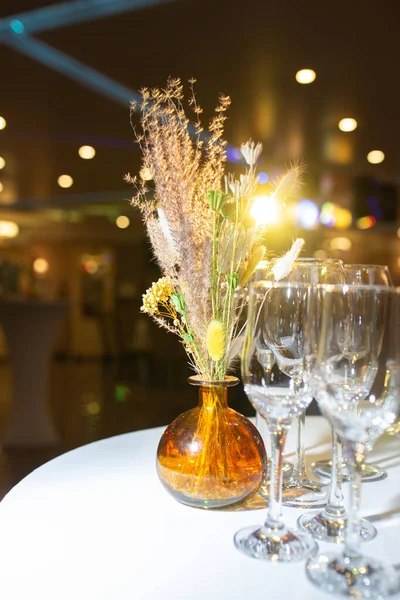 decorative vases with dried flowers on the table at the festival.