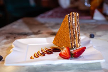 Traditional Russian Honey Cake Medovik on restaurant plate.