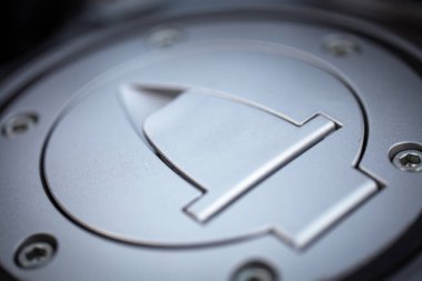 metal gas tank cover on a motorcycle close-up.