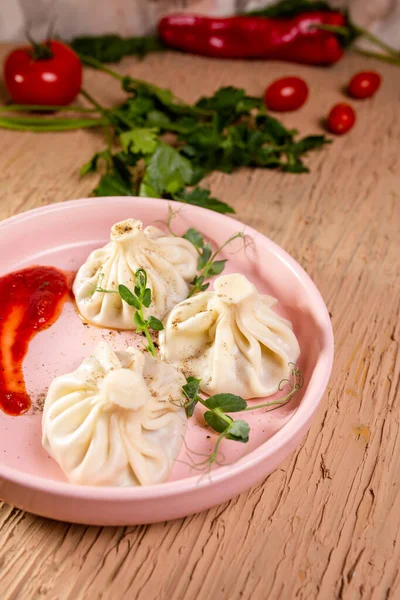 stock image khinkali with red sauce on a plate in a restaurant