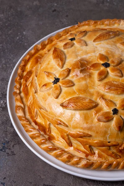 hot homemade chicken pie with filling. pie on the table.