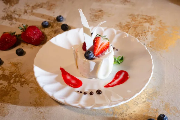 Stock image a beautiful fresh white dessert in a restaurant on the table. original dessert serving.