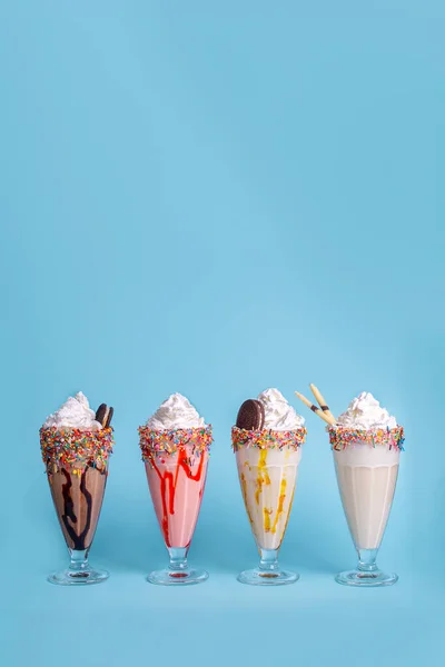 assorted milkshakes on a blue background. photos for the menu.