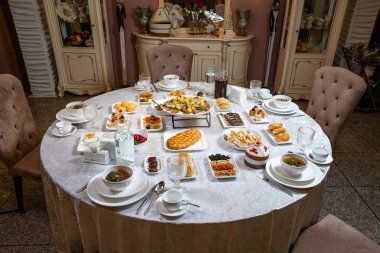 Lavishly served banquet table with soups, appetizers, pastries, and desserts. Top view, elegant presentation, perfect for restaurants, menus, and events.