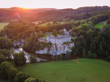 beautiful sunset over the castle walzin in forest clipart