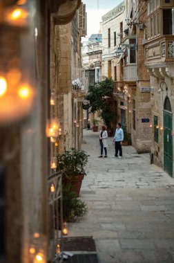 Citta Vittoriosa, Malta - 8 Ekim 2022: Birgufest sırasında mumlarla parlayan antik Citta Vittoriosa caddeleri gibi insanlar Birgu 'nun Candlelight' taki büyülü atmosferinin tadını çıkarıyorlar.