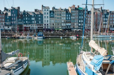 Honfleur 'da yarım ahşap evler, antika dükkanlar ve canlı çiçek sergileriyle dolu pitoresk kaldırımlı bir cadde eski dünya cazibesini yakalıyor.