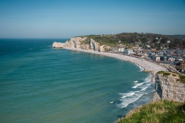Etretat 'ın ikonik tebeşir kayalıkları ve turkuaz suları güneş ışığı altında parlayarak Normandiya' nın doğal güzelliğini ve huzurlu sahil şeridini gözler önüne seriyor..