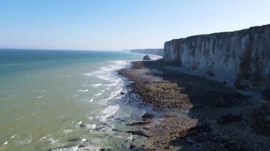 Etretat 'ın ikonik tebeşir kayalıkları ve turkuaz suları güneş ışığı altında parlayarak Normandiya' nın doğal güzelliğini ve huzurlu sahil şeridini gözler önüne seriyor..
