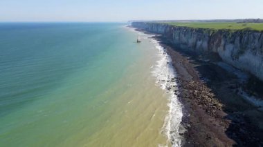 Etretat 'ın ikonik tebeşir kayalıkları ve turkuaz suları güneş ışığı altında parlayarak Normandiya' nın doğal güzelliğini ve huzurlu sahil şeridini gözler önüne seriyor..