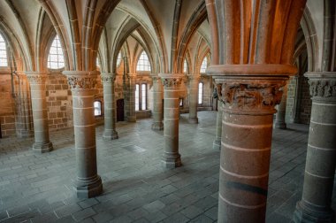 Mont Saint-Michel Manastırı 'nın sakin ve tarihi iç kısımları taş kemerler, antik duvarlar ve dar pencerelerden süzülen yumuşak doğal ışık..
