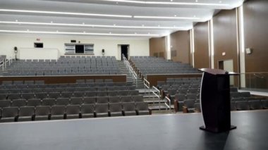 Stadyum oturma yeri ve podyumu olan bir sanat salonu sahnesi.